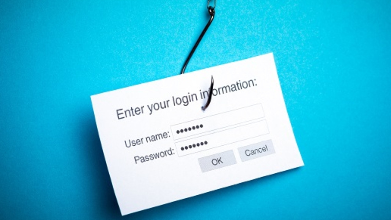 Black fishhook that has hooked a card that says "Enter your login information" with user name and password fields filled 