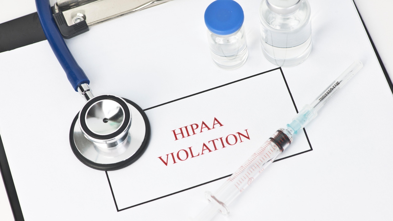 "HIPAA Violation" written on a form, surrounded by medical supplies