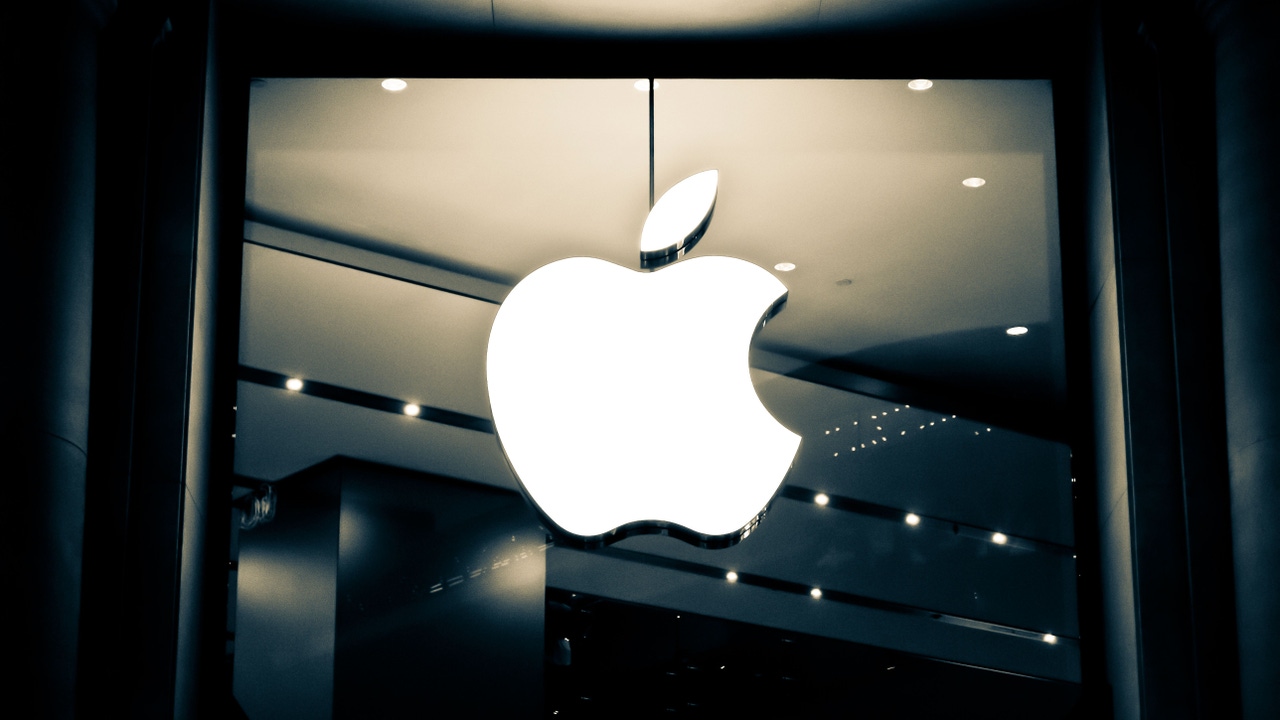 Glowing Apple logo on a window