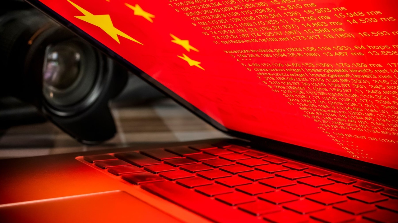 The Chinese flag on a laptop screen that is partially closed The Chinese flag on a laptop screen that is partially closed