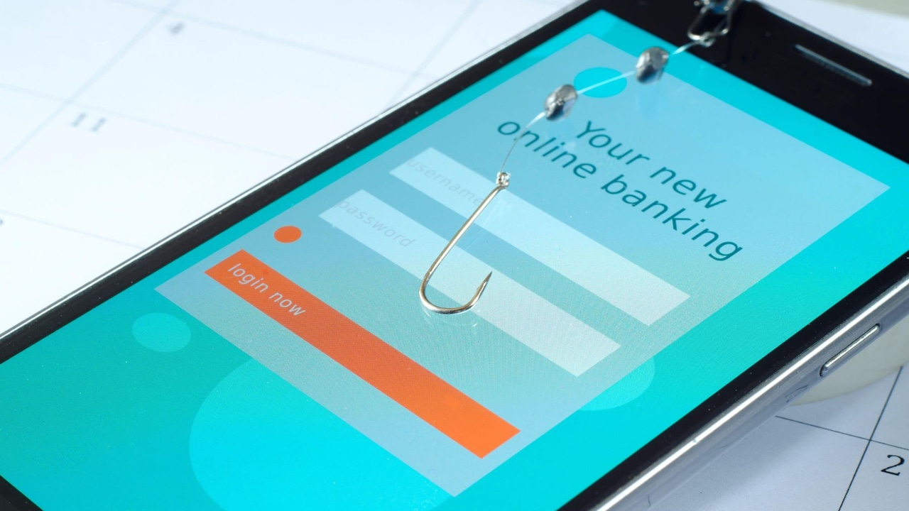 Fishing hook over a smartphone screen with a fake login being displayed Fishing hook over a smartphone screen with a fake login being displayed