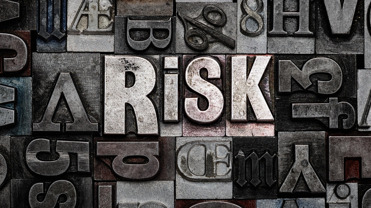 The word "RISK" made from old metal letterpress letters